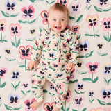 Kip & Co Pretty Pansy organic long sleeve zip romper for babies, featuring floral print and soft cotton fabric.