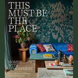 Cover image of "This Must Be The Place – Homes With Atmosphere" book by Brumby Sunstate, featuring a cozy home scene.