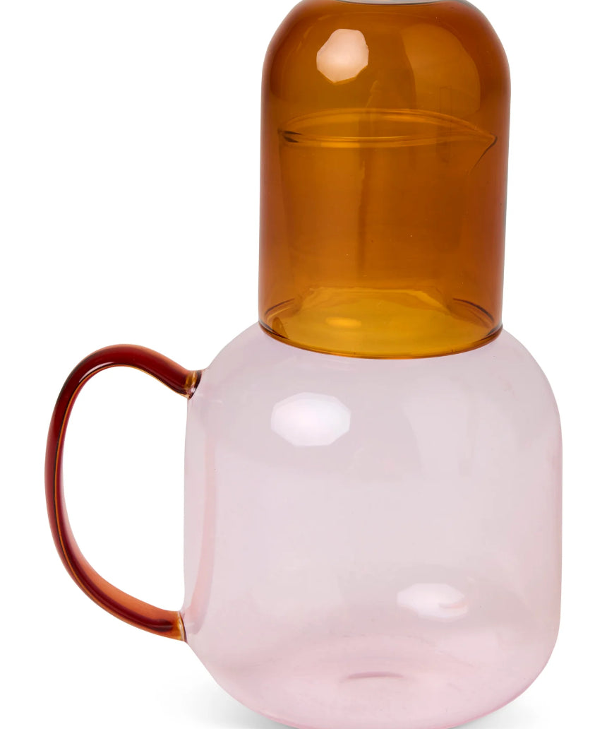 Kip & Co marshmallow and marmalade glass carafe with matching glass set on a wooden surface.