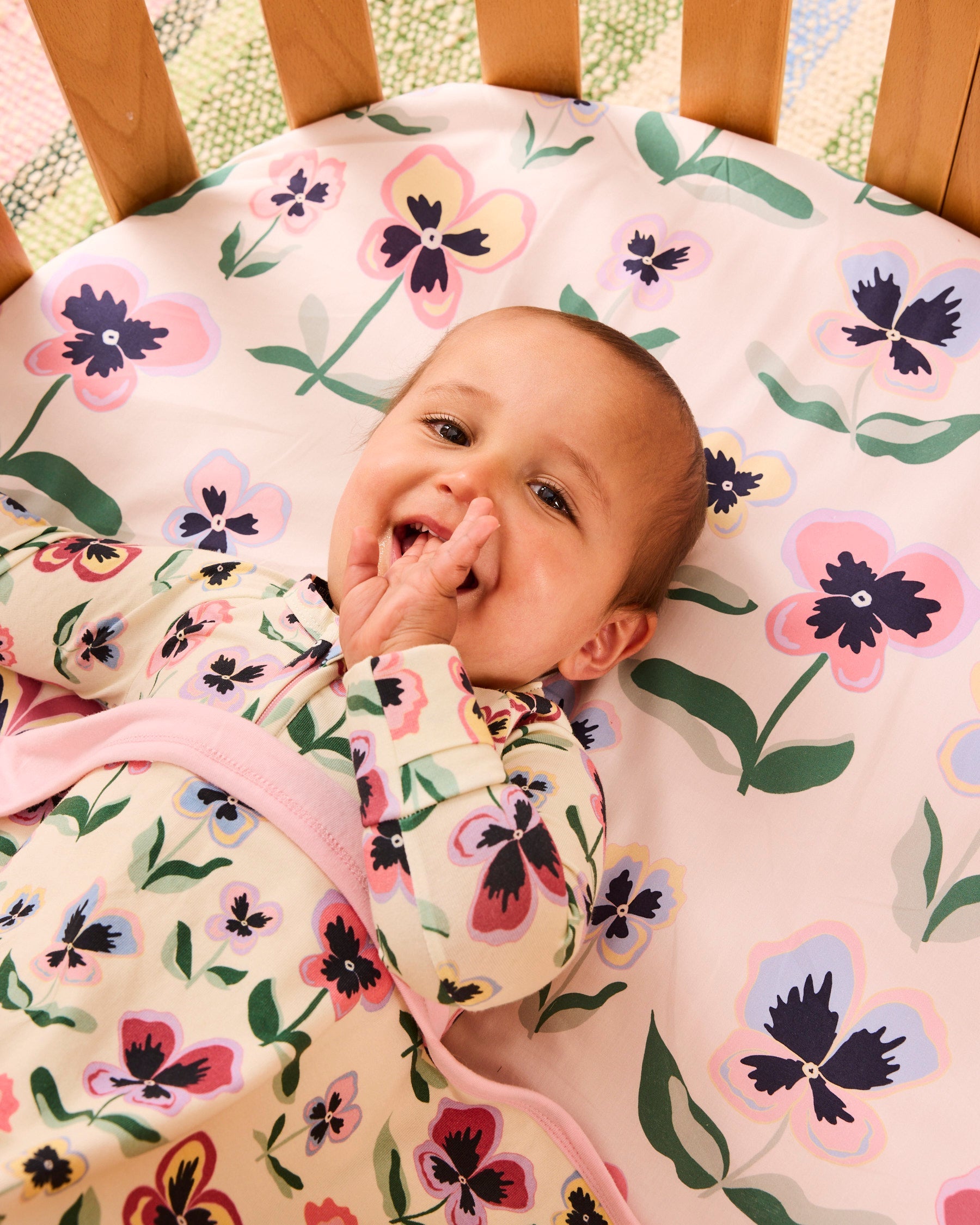 Kip & Co Pretty Pansy organic cotton baby blanket with colorful floral pattern, soft and cozy for infants.