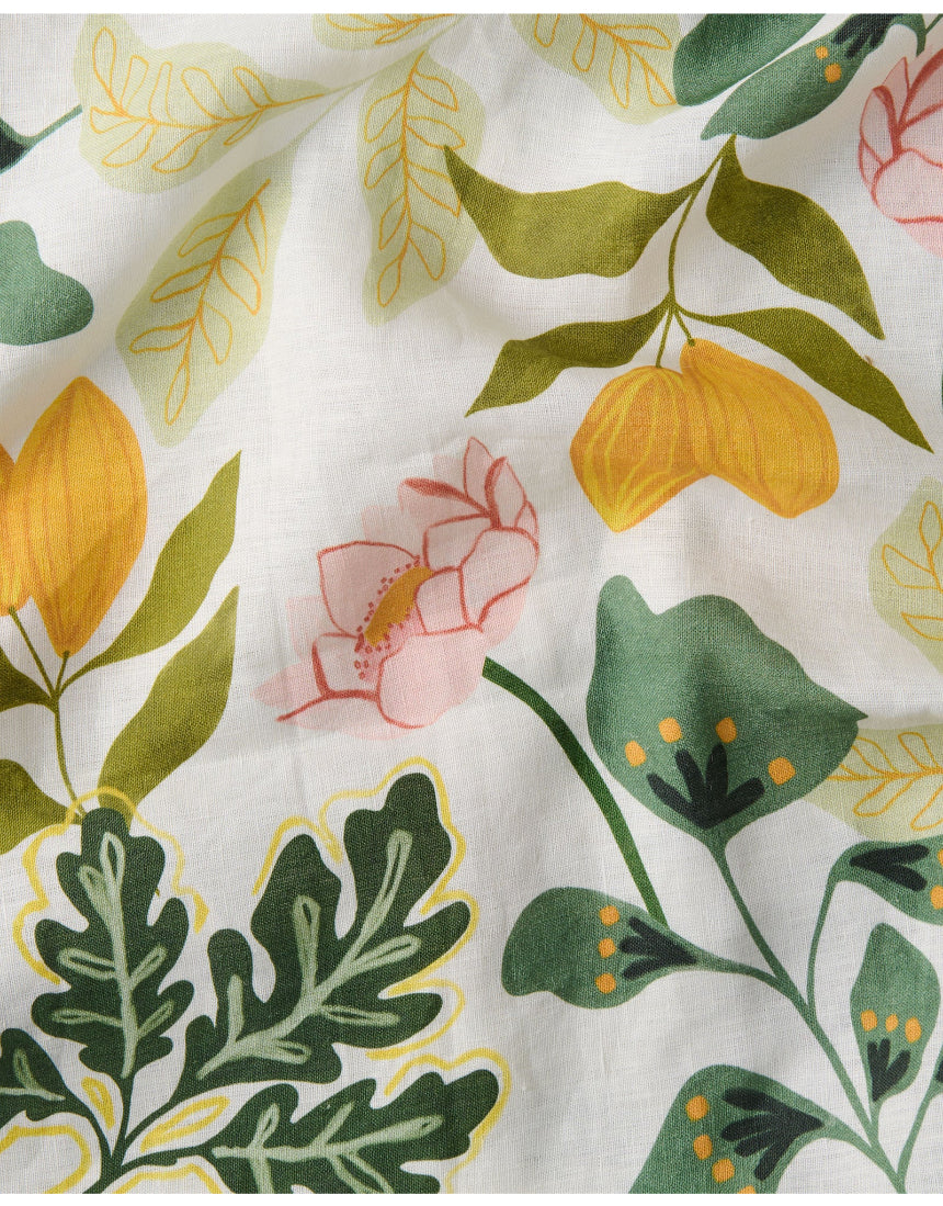 Kip & Co Wander apron with colorful, patterned fabric, tied waist, and adjustable neck strap for cooking or baking.