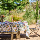 Kip & Co Wander rectangular tablecloth with colorful, patterned fabric draped over a dining table.