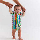 Kip & Co baby short sleeve romper featuring colorful beach pattern, lightweight cotton fabric, perfect for warm weather.