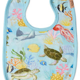 Kip & Co Reef Life cotton baby bib with colorful ocean-inspired print and adjustable neck closure.