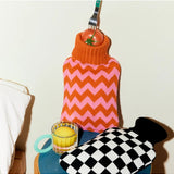 Casa Rolio hot water bottle with orange cover, tangerine color, soft fabric cover, and a flexible rubber bottle for warmth.