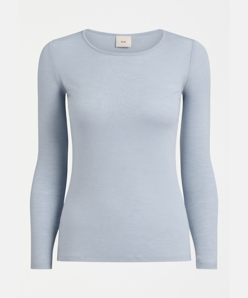 Elk Merino Long Sleeve Top in Pearl Blue, showcasing a soft, fitted wool shirt with long sleeves and a high neckline.