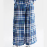Elk Ranie Pant in blue multi-check pattern, casual pants with a relaxed fit, shown on a model in a natural outdoor setting.