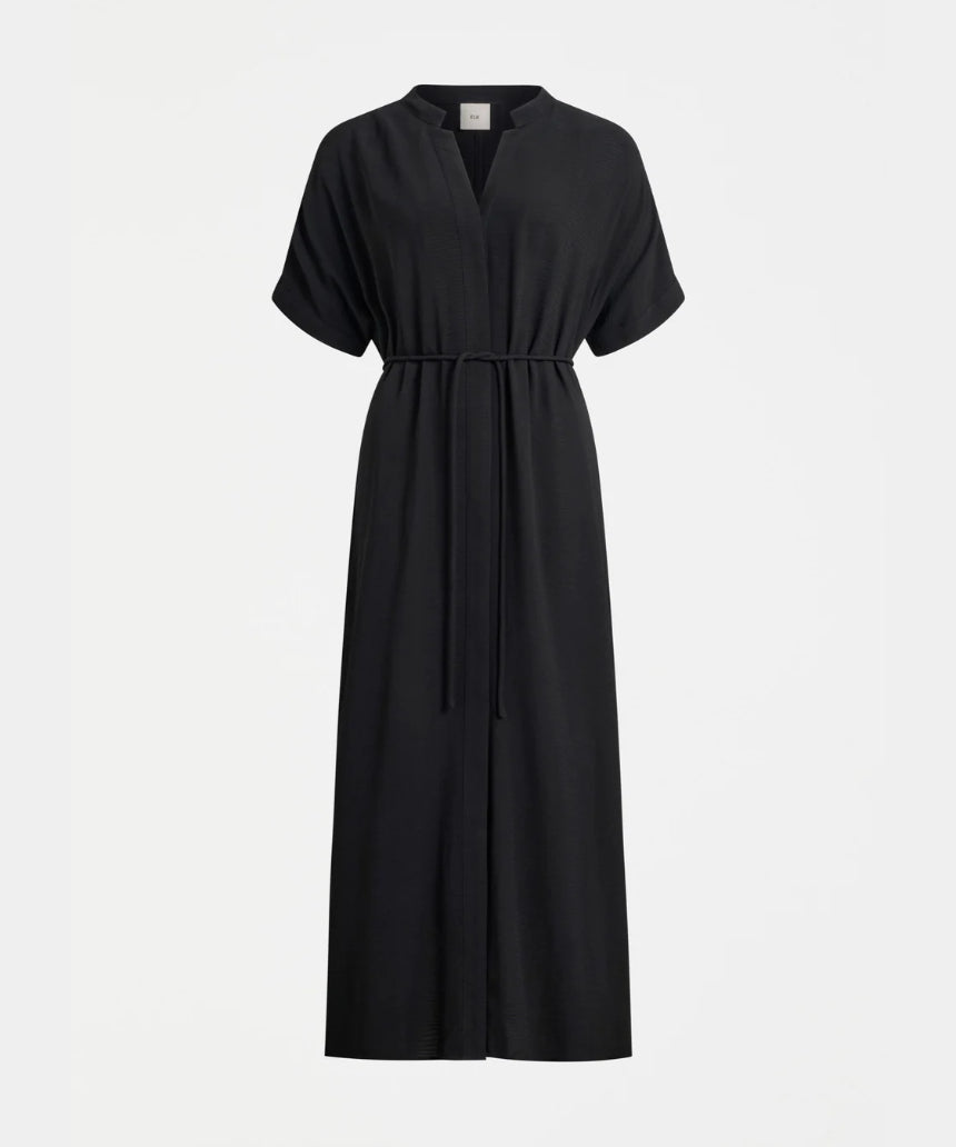 Black Elk Omia shirt dress hanging on a wooden hanger, showcasing a casual and stylish clothing piece with a button-up front.