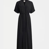 Black Elk Omia shirt dress hanging on a wooden hanger, showcasing a casual and stylish clothing piece with a button-up front.