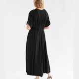 Black Elk Omia shirt dress displayed on a hanger, featuring a relaxed fit and classic collar for versatile styling.