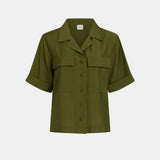 Elk Eine Bright Olive shirt displayed on a hanger, showcasing its casual design and vibrant olive color.