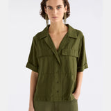 Elk Eine Shirt in Bright Olive color, casual clothing with a relaxed fit, displayed on a hanger.