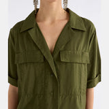 Elk Eine Bright Olive Shirt in green, casual clothing with a relaxed fit, displayed on a hanger against a neutral background.