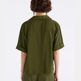 Elk Eine Shirt in Bright Olive, a casual men's clothing top with a relaxed fit and short sleeves, displayed on a hanger.