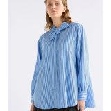 Elk Hedi shirt in chambray stripe, casual men's clothing with a button-up front and long sleeves, displayed on a hanger.