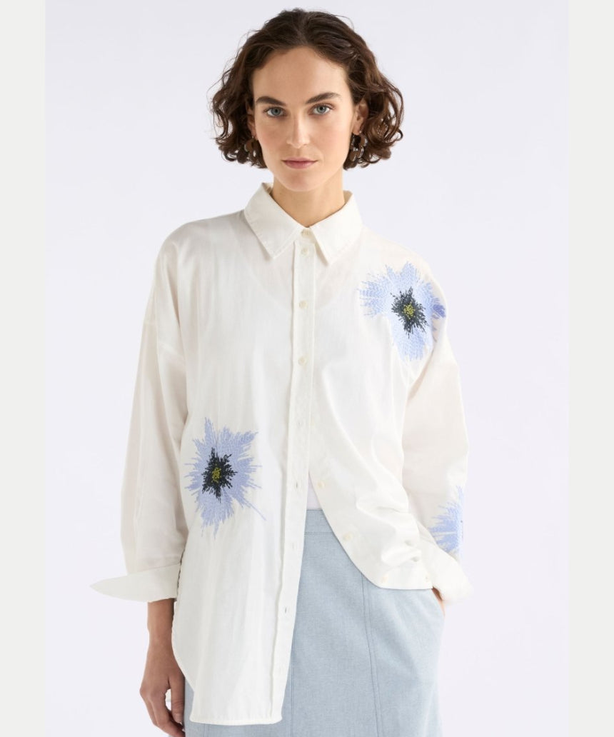Elk Eiren relaxed shirt in white, lilac, and blue, featuring a casual fit and soft fabric, displayed on a hanger.