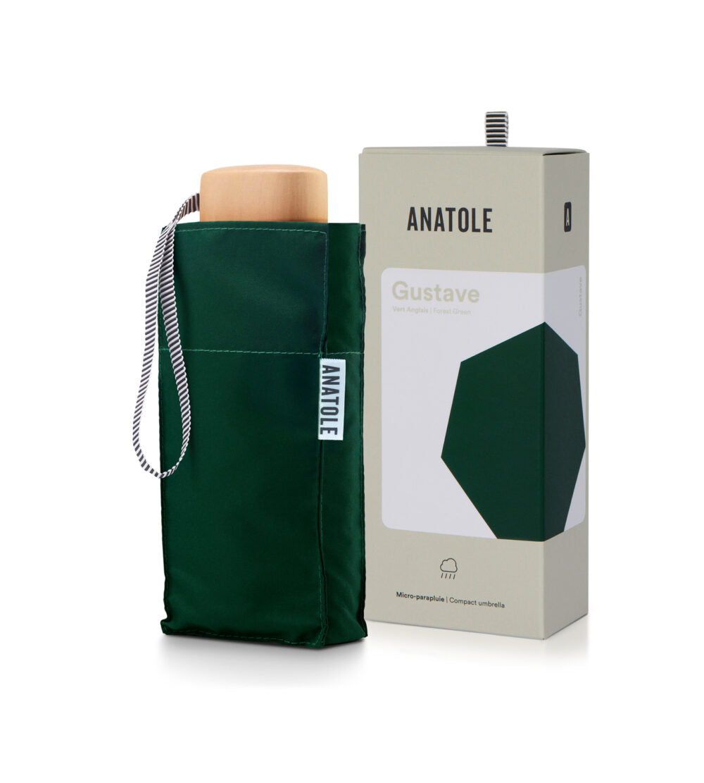 Green Anatole Gustave micro-umbrella with compact design, shown open with fabric canopy and handle for easy portability.