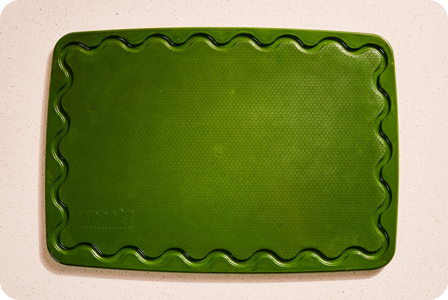 Maison Apprêt petite green chopping board, made of durable wood, ideal for food prep and serving in the kitchen.