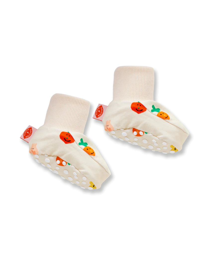 Close-up of Halcyon Nights Teeny Tiny Veg Baby Booties, soft baby clothing footwear with colorful vegetable designs.