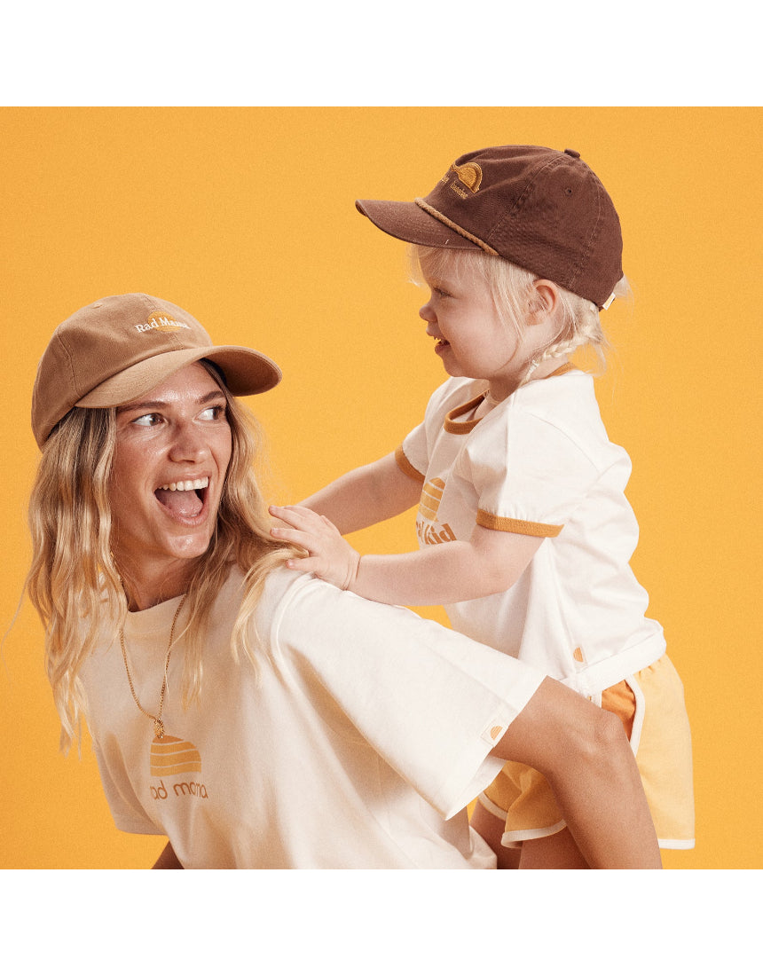 Banabae Rad Mama Washed Baseball Cap in Desert Sand, showing a soft, faded fabric cap with a curved brim and adjustable strap.