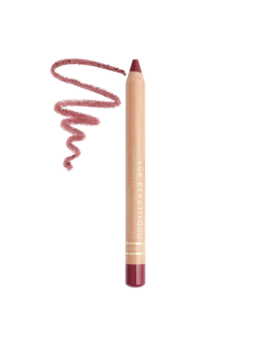 Lük Beautifood Natural Lipstick Crayon in Berry Bite swatched on skin showing deep berry color and creamy texture.