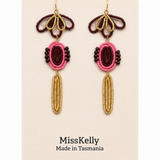 Miss Kelly Madison statement earrings featuring bold, geometric gold-tone design on a white background.