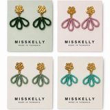 Gold floral earrings by Miss Kelly featuring petal-shaped design, elegant jewelry accessory for women.