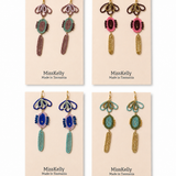 Miss Kelly Madison statement earrings featuring bold, stylish gold-tone design with intricate detailing and dangle style.