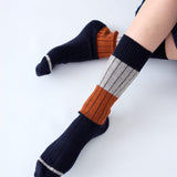 Tightology chunky rib Merino wool socks in midnight color, featuring thick knit texture and cozy, warm design for cold weather.