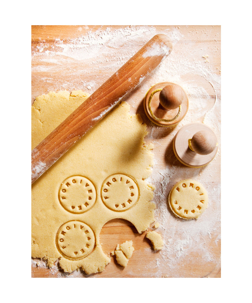 Suck UK customizable cookie stamp with engraved design, showing the stamp pressed onto freshly baked cookies.