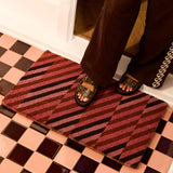 Pink patchwork door mat by Bonnie and Neil featuring vibrant, colorful patterns for welcoming entryways.