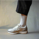 White glitter lurex socks by Klue, showcasing shiny, textured fabric and comfortable fit, perfect for stylish casual wear.