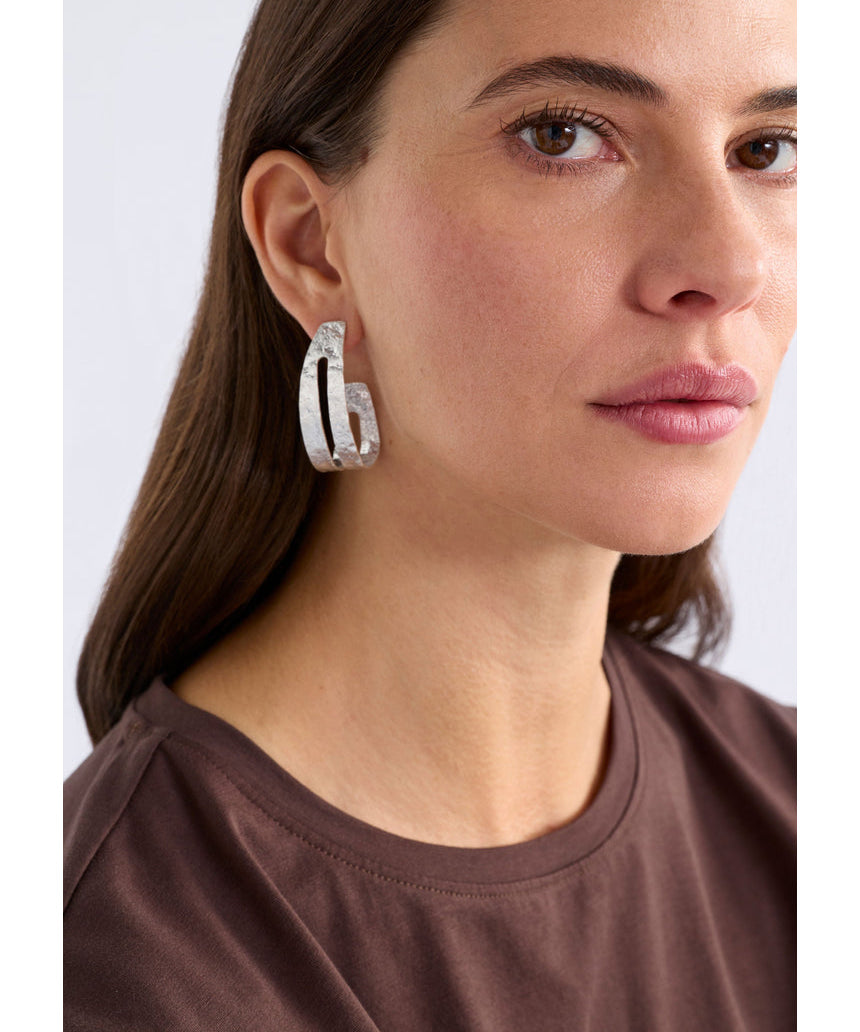 Silver Amner large hoop earring by ELK The Label, showcasing a sleek, polished hoop design with a modern, minimalist style.