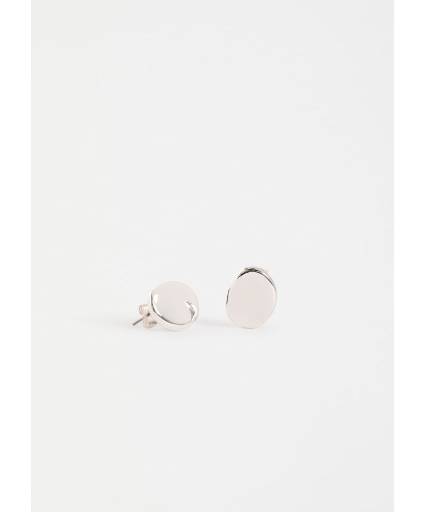 Silver Elk Atur Mini Stud Earrings from ELK The Label featuring small, sleek silver earrings on a plain background.