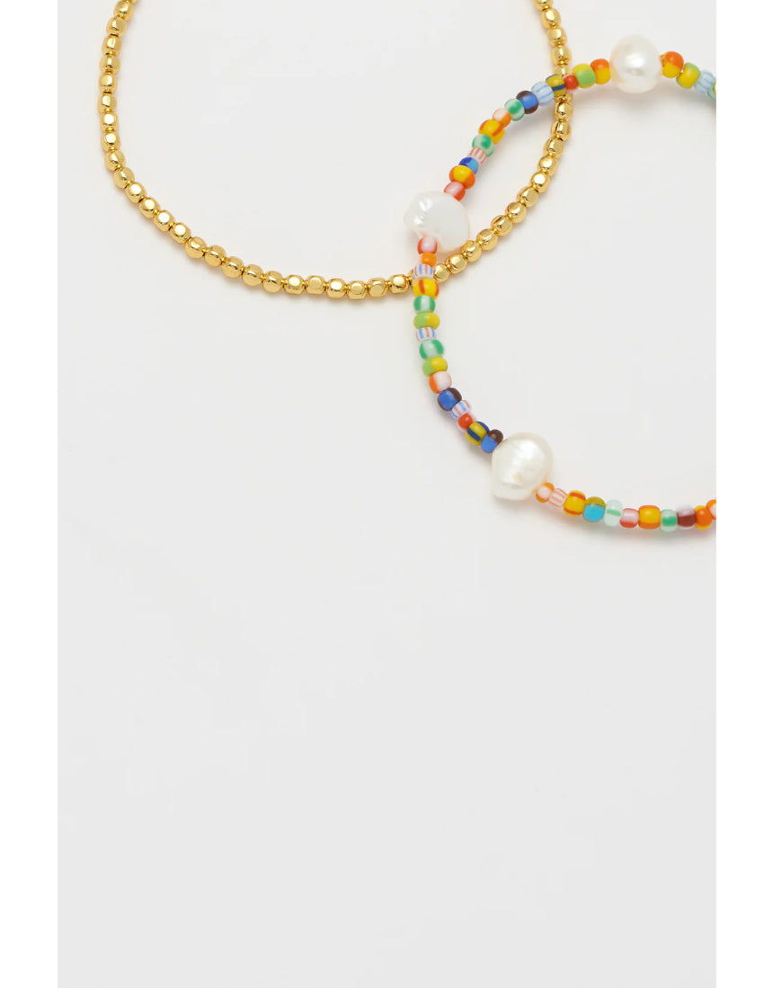 Estella Bartlett rainbow pearl bracelet set featuring colorful pearl strands and delicate silver accents on a white background.