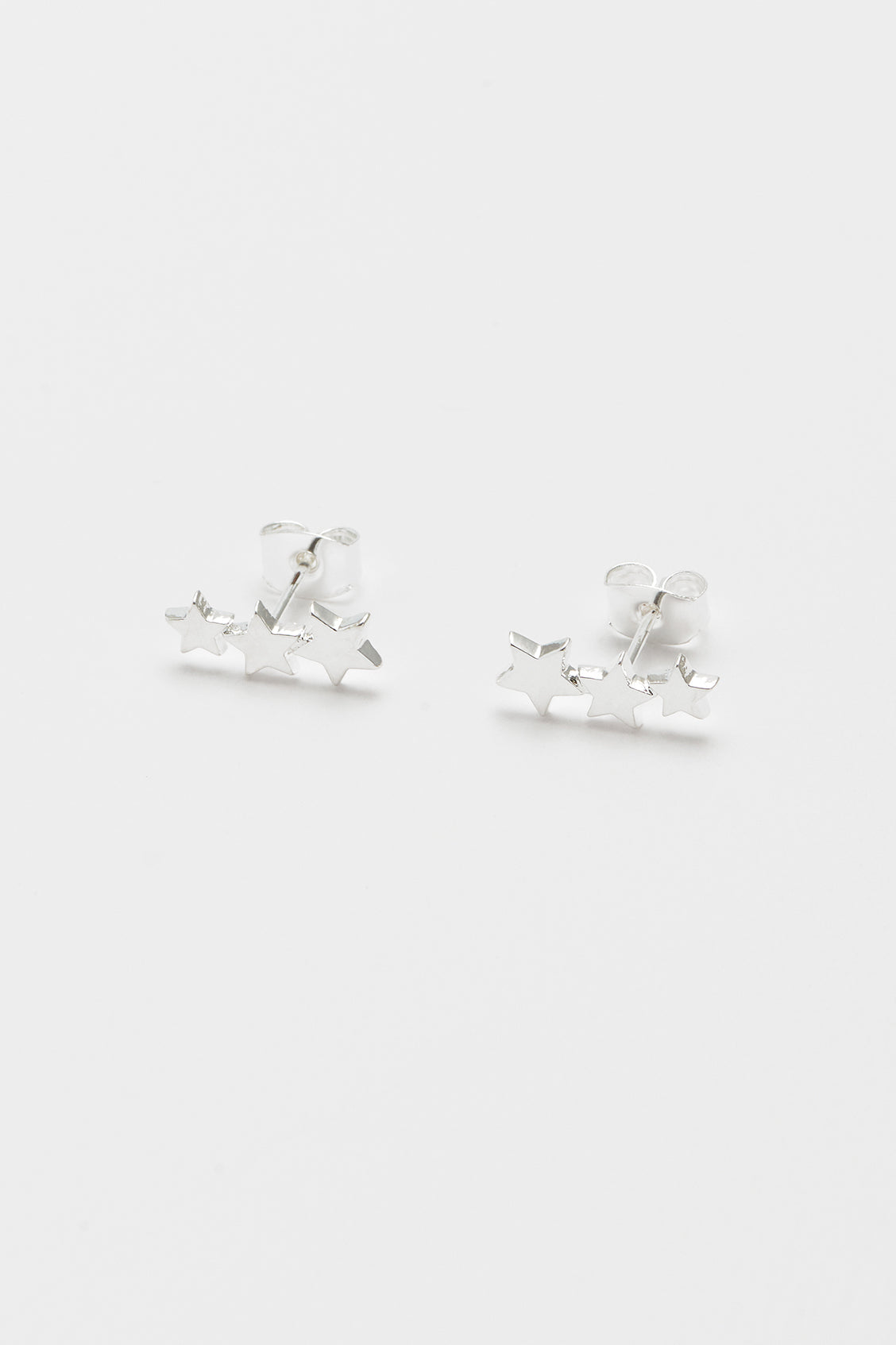 Silver plated Estella Bartlett star crawler stud earrings, showcasing a delicate celestial design in jewelry style.