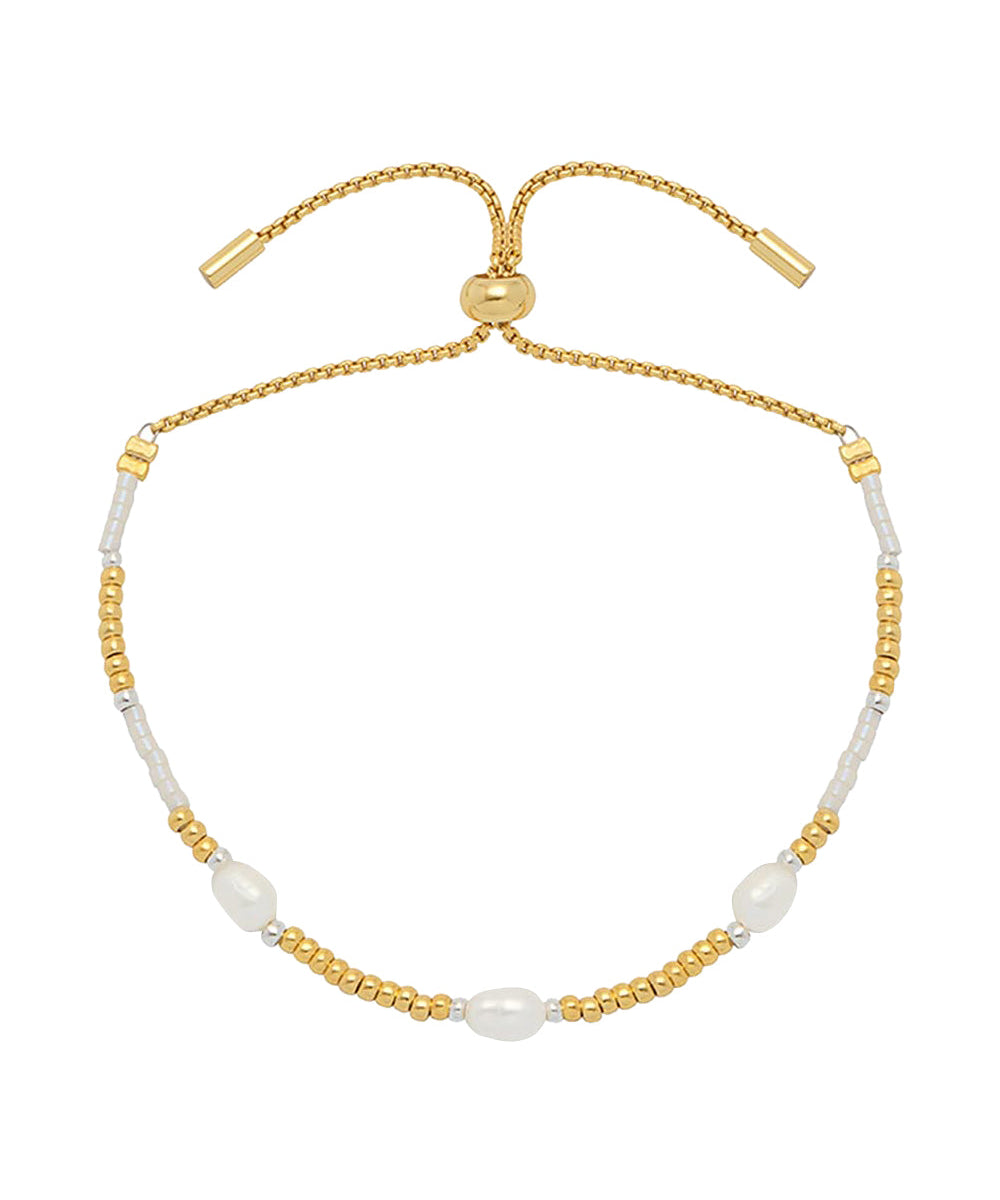 Estella Bartlett Pearl Station Gold Amelia Bracelet featuring a delicate gold chain with pearl accents on a jewelry display