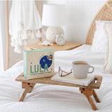 Lula self-warming eucalyptus and tea tree eye mask lying flat on a white surface, showing soft fabric and adjustable strap.
