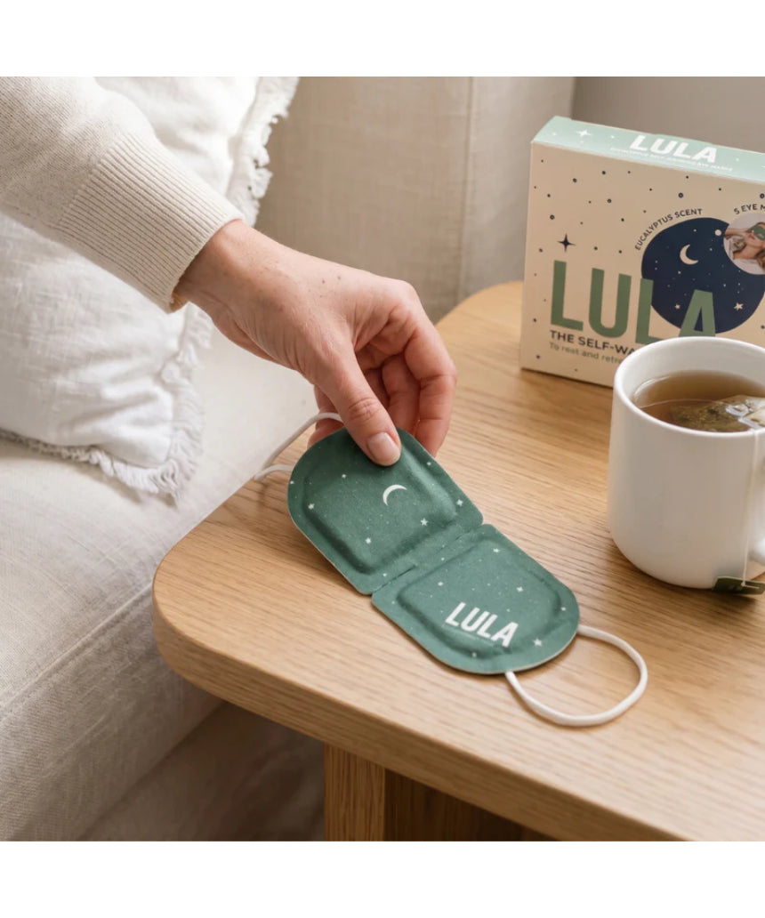 Lula self-warming eucalyptus and tea tree eye mask, shown in a soft fabric with a calming green design.