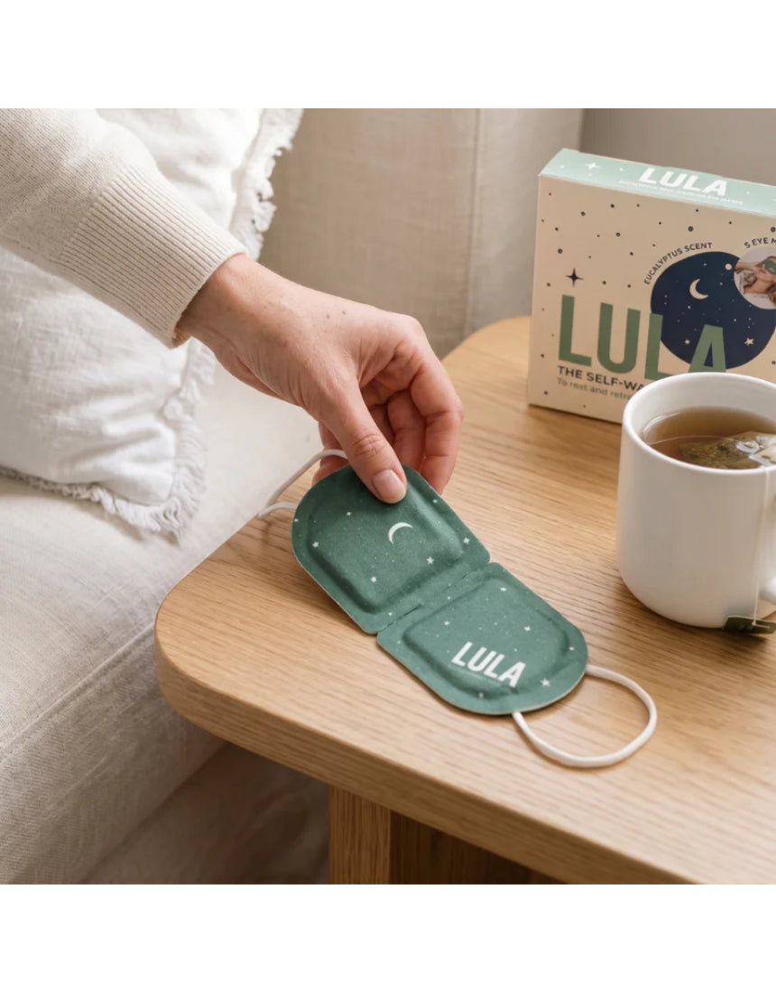 Lula self-warming eucalyptus and tea tree eye mask, shown in a soft fabric with a calming green design.