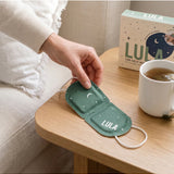 Lula self-warming eucalyptus and tea tree eye mask, shown in a soft fabric with a calming green design.