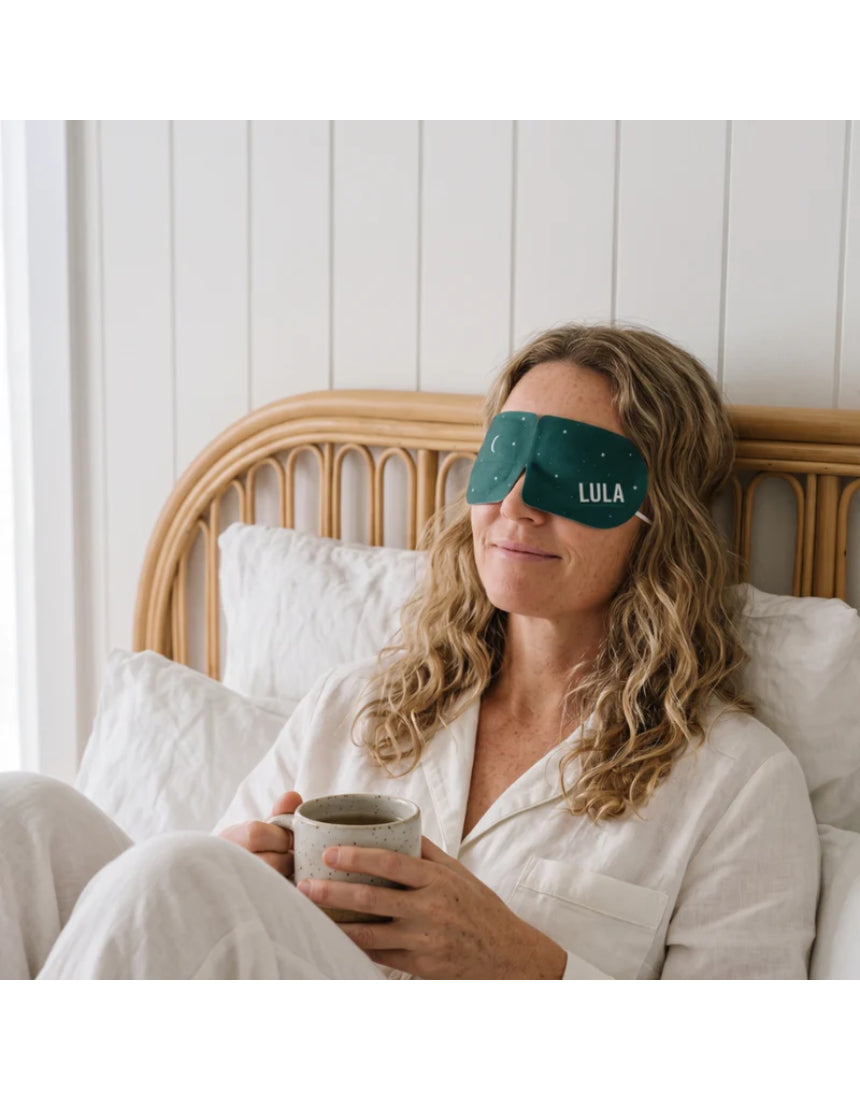 Lula self-warming eucalyptus and tea tree eye mask showing soft fabric and adjustable strap for relaxation and soothing relief.
