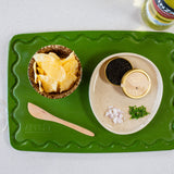 Green Maison Apprêt petite chopping board with smooth surface, ideal for preparing food in modern kitchens.