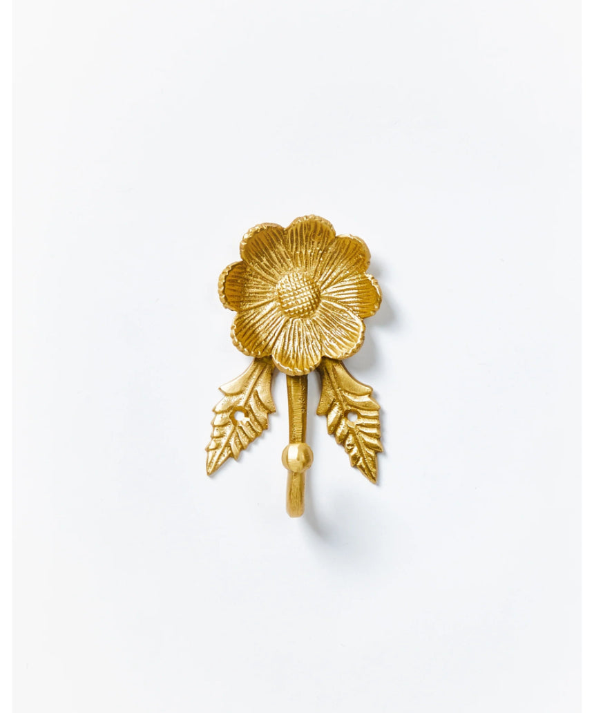 Brass Daisy Wall Hook by Bonnie and Neil, featuring a floral daisy design, mounted on a wall for decorative hanging.