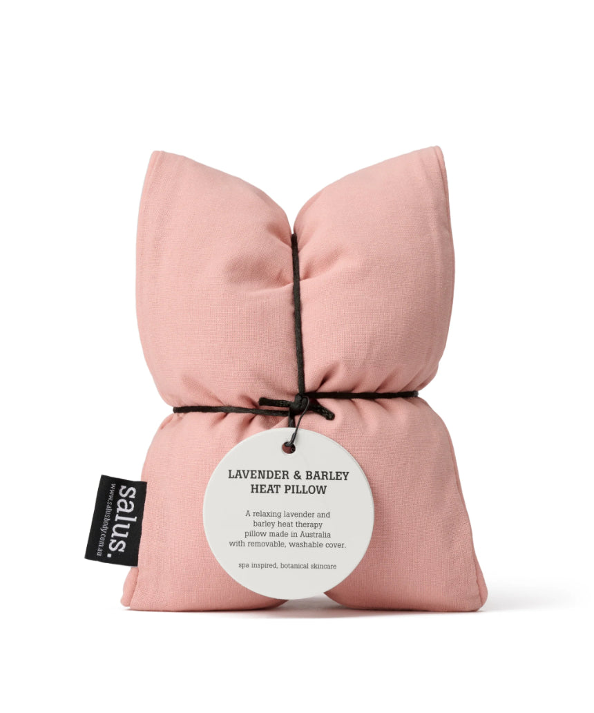 Salus lavender and barley heat pillow in blush color, soft fabric with a cozy, plush appearance, designed for relaxation and warmth.