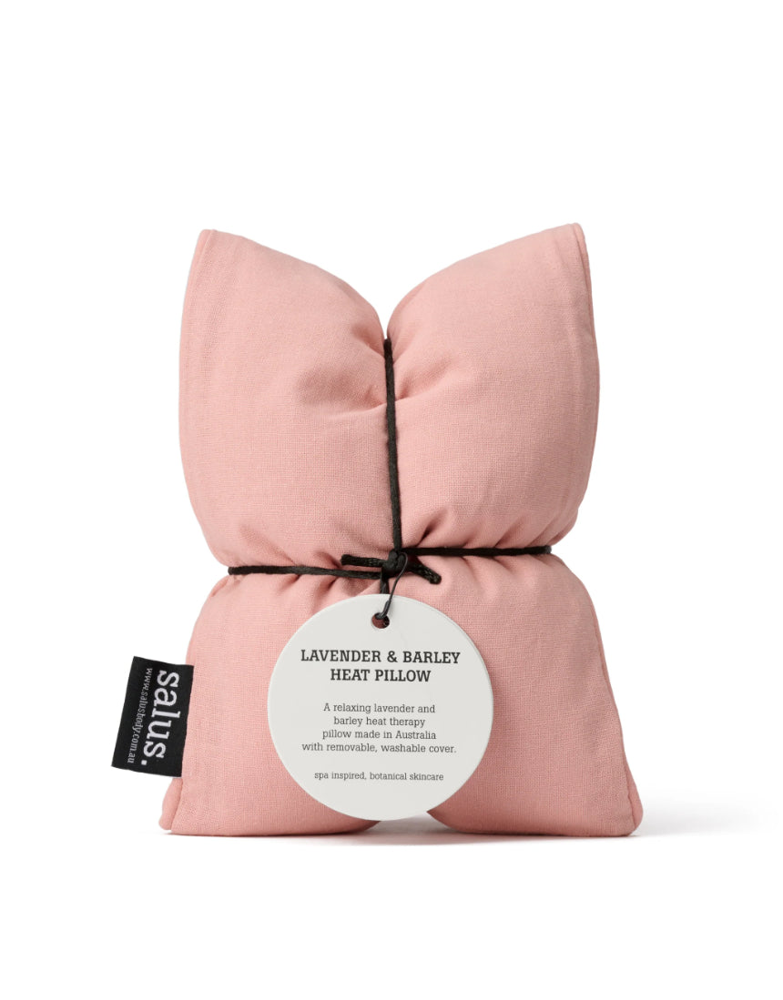Salus lavender and barley heat pillow in blush color, soft fabric with a cozy, plush appearance, designed for relaxation and warmth.