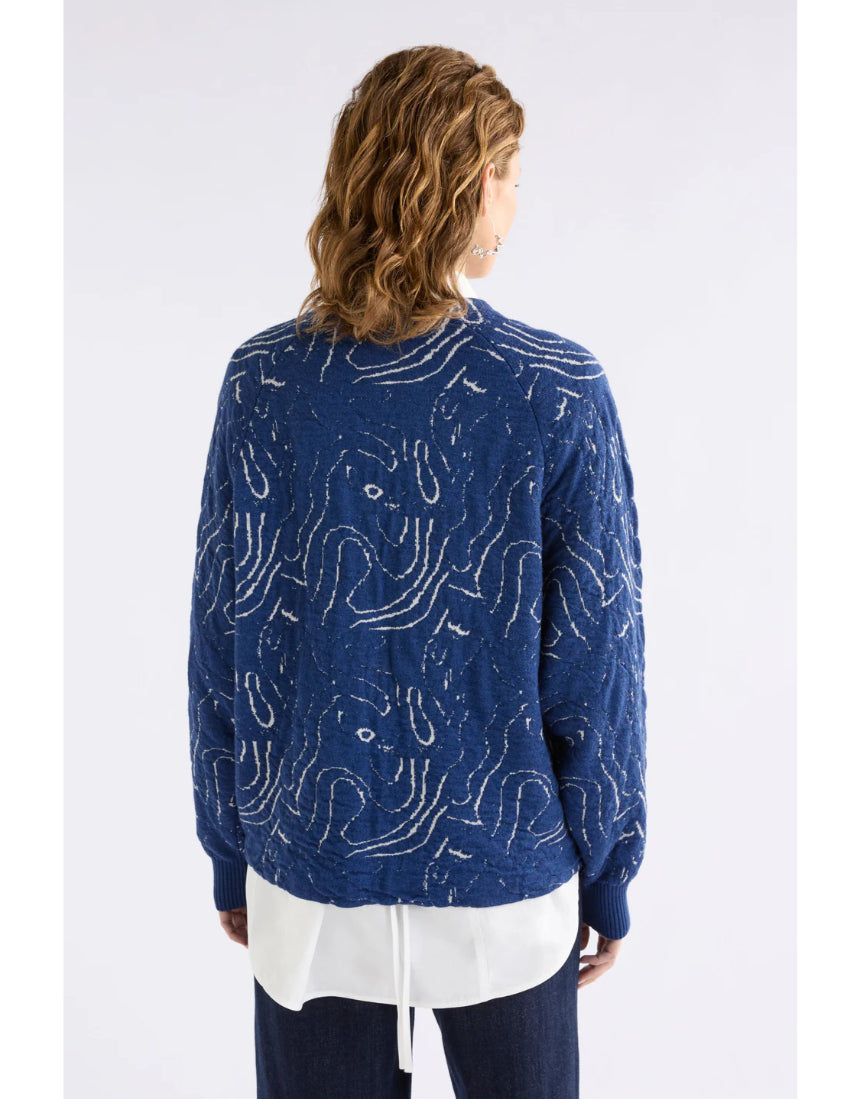 Elk Otillia Sweater in blue and silver, featuring a cozy knit design with long sleeves and ribbed cuffs.