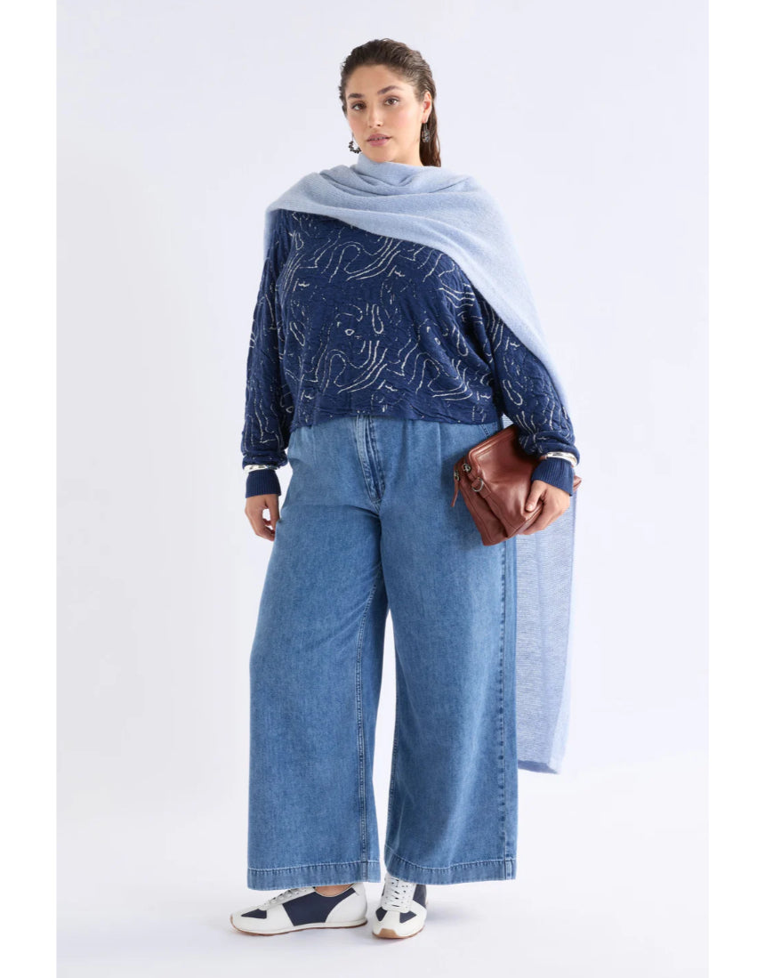 Elk Otillia sweater in blue and silver, featuring a cozy knit design and ribbed cuffs, displayed on a hanger.