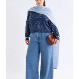 Elk Otillia sweater in blue and silver, featuring a cozy knit design and ribbed cuffs, displayed on a hanger.