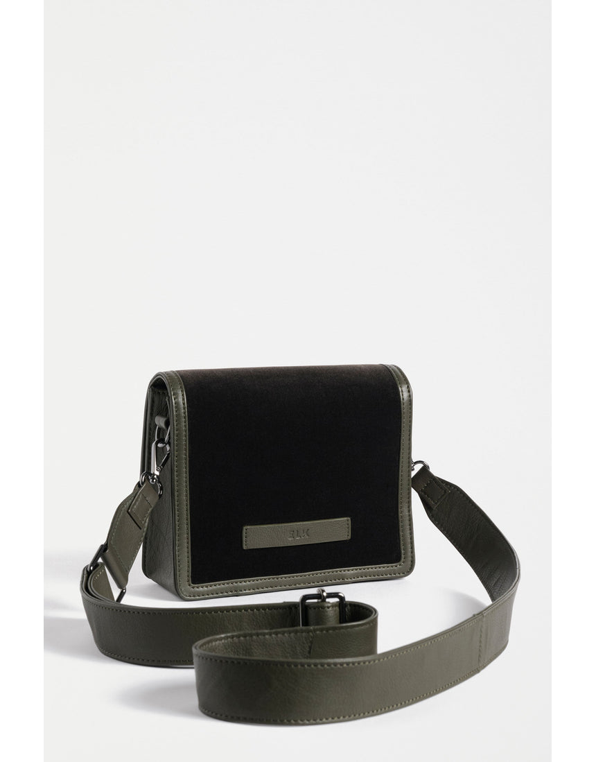 Dark olive ELK The Label Vel crossbody bag with adjustable strap and sleek design, shown hanging with a subtle texture.